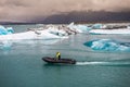 A man swims through the ice-covered ocean on a motor boat, South coast, warm waters of the Gulf stream; Iceland, Vic, December 12,
