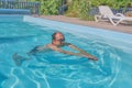 A man swims in a pool in the courtyard Royalty Free Stock Photo