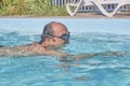 A man swims in a pool in the courtyard Royalty Free Stock Photo