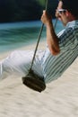 Man on swing at beach Royalty Free Stock Photo