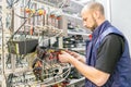 Man switches audio and video cable on the patch panel. Worker works on the control panel in the data center. Specialist connects