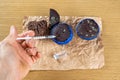 Man with syringe injecting insulin into moldy chocolate muffin_top view Royalty Free Stock Photo