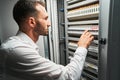 Man system administrator pressing on electrical switch Royalty Free Stock Photo