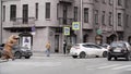 Man in t rex costume prankster walking at city street crosswalk