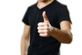 A man in a t-shirt shows his thumb up. Close up. Isolated background Royalty Free Stock Photo