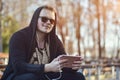 A Man with a tablet computer sits in an open-air park Royalty Free Stock Photo