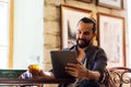 Man with tablet pc drinking beer at bar or pub Royalty Free Stock Photo