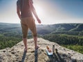 Man take break for snack while climbing in rocks. Hiker in shorts Royalty Free Stock Photo