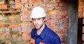 Man take break working day at construction site. Builder helmet construction site sit relaxing lean brick wall. Guy Royalty Free Stock Photo