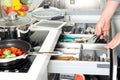 Man take off a stainless tool in the kitchen . Vegatables behind Royalty Free Stock Photo