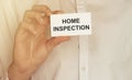 Man take a paper with text HOME INSPECTION on the shirt Royalty Free Stock Photo
