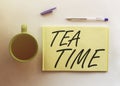 Man take a paper with text Tea Time on the shirt with office background Royalty Free Stock Photo