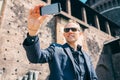 Man take a self picture with his smartphone near the old castle Royalty Free Stock Photo