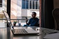 Man takes a break from teleworking by looking at his smartphone