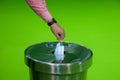 A man takes off protective medical mask and dumping into trash can. Royalty Free Stock Photo