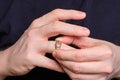 A man takes off a wedding ring from a finger of his hand Royalty Free Stock Photo