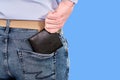 The man takes out a black purse from his back pocket, close up Royalty Free Stock Photo