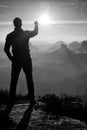 Man takes phone photos.Dreamy fogy mountains while sunrise