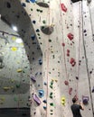 Man takes photo of rock at rock climbing wall