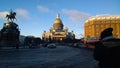 A man takes a picture of the sights of St. Petersburg: St. Isaac`s Cathedral and monument to Nicholas the First on a Sunny day Royalty Free Stock Photo