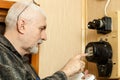 A man records the readings of an electricity meter Royalty Free Stock Photo