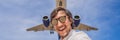 A man takes a selfie against the sky and a flying plane BANNER, LONG FORMAT Royalty Free Stock Photo