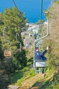 A man takes a selfie, going down the cable car from the highest point of the island of Capri - Monte Solaro