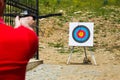 Man taking aim with a crossbow at a target Royalty Free Stock Photo