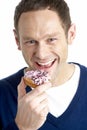 Man Taking Bite Of Doughnut Royalty Free Stock Photo