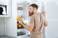 Man taking bottle with juice out of refrigerator Royalty Free Stock Photo