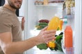Man taking bottle with juice out of refrigerator Royalty Free Stock Photo