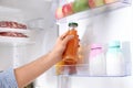 Man taking bottle with juice out of refrigerator in kitchen Royalty Free Stock Photo