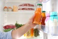 Man taking bottle with juice out of refrigerator in kitchen Royalty Free Stock Photo