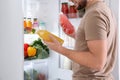 Man taking bottles with juice out of refrigerator Royalty Free Stock Photo