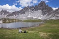 Man taking a break during hiking with view at lake Bloedensee at the Three Peaks in the European Dolomite Alps, South Tyrol Italy