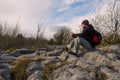 Man taking break on a stone. Royalty Free Stock Photo