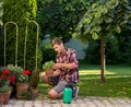 Man taking care of plants in garden