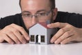 Man taking a close look at the model house. Royalty Free Stock Photo