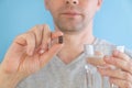 Man taking gastrointestinal adsorbent pill with glass of water for the treatment of intestinal dysbiosis, diarrhea