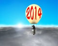 Man taking lamp balloon floating over clouds, looking at sun Royalty Free Stock Photo