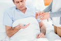 Man taking medicines and woman holding glass of water Royalty Free Stock Photo