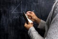Man taking notes of math theorem on blackboard