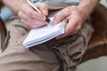 Man taking notes on a pocket book