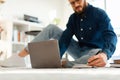 Man Taking Notes Using Laptop Sitting On Floor Indoors, Cropped Royalty Free Stock Photo