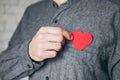Man taking out red paper heart from the front pocket of his shirt Royalty Free Stock Photo