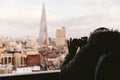 Man taking photo with camera of modern London winter skyline Royalty Free Stock Photo