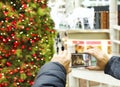 Man taking a photo of Christmas tree in shopping centre with cellphone, Toronto, Canada Royalty Free Stock Photo