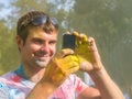 Man taking photo on mobile phone on holi color festival Royalty Free Stock Photo