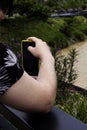 Man taking a photo of polluted river in Medellin