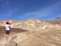 Man taking photograph of Artists palette at Death Valley National Park in California USA Royalty Free Stock Photo